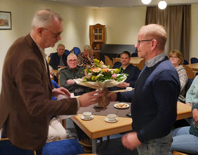 Bürgermeister Harders überreicht Dieter Ertwiens-Buchwald einen Blumenstrauß.